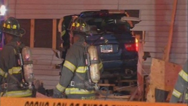 A New Haven man woke up to a real-life nightmare early Tuesday morning when a car police were pursuing slammed into his apartment while he was sleeping in bed and landed on top of him.