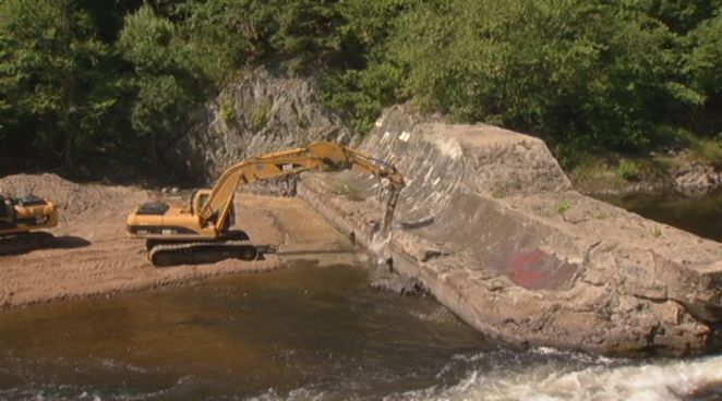The process of removing the Spoonville dam along the Farmington River has begun. It was once used to generate power, but is now is being dismantled to help restore fish populations.
