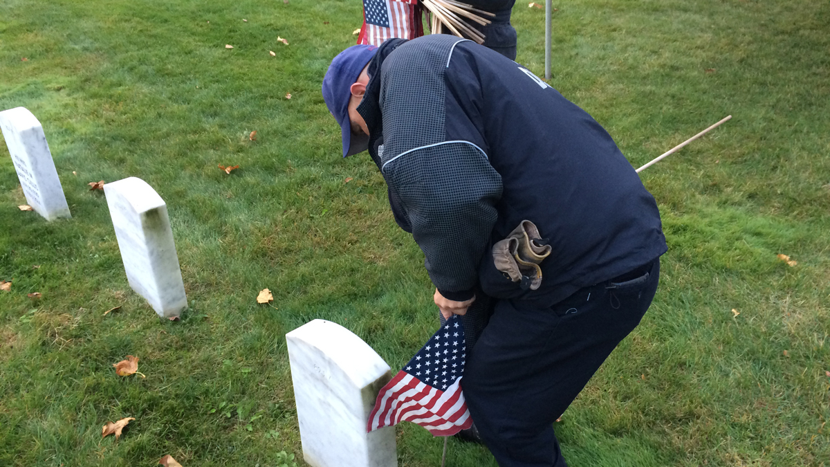Volunteers Honor Veterans by Placing Flags at Cemeteries