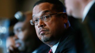 In this Dec. 2, 2016, file photo, U.S. Rep. Keith Ellison, D-Minn., listens as Ray Buckley, chair of the party in New Hampshire, speaks during a forum on the future of the Democratic Party in Denver, Colorado. The candidates spoke during the Association of State Democratic Chairs session.