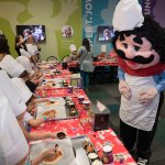 Chuck E. Cheese's Chef Pasqually, right, interacts with children as they learn how pizza is made at the San Antonio Chuck E. Cheese's 2017 reopening, Aug. 9, 2017.