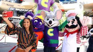 Chuck E. Cheese mascots celebrate "National Pizza Month" with Christina Milian, left, on Wed., Oct. 4, 2017 in Los Angeles.