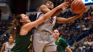South Florida's Cristina Bermejo, left, fouls Connecticut's Crystal Dangerfield in the first half of an NCAA college basketball game, Monday, March 2, 2020, in Hartford, Conn.