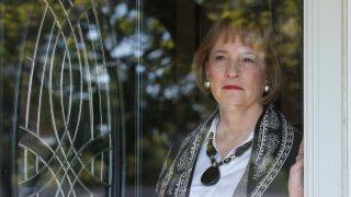 Lynne Gist looks out of the front door of her home
