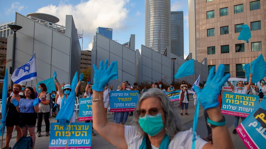 Israeli and Arab women block a road during a protest against Israel's planned annexation of the Jordan Valley, in Tel Aviv, Israel, Thursday, June 18, 2020.