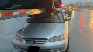 CAR WEDGED UNDER A TRACTOR TRAILER