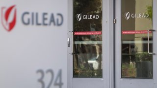 Signs display the company logo at the headquarters of Gilead Sciences Inc., in Foster City, California, March 19, 2020.