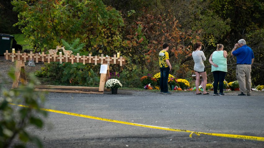 Mourners visit the site of a fatal limousine crash that killed 20 people near the intersection of Route 30 South and Route 30A, October 10, 2018 in Schoharie, New York. 20 people died in the crash on Saturday, including the driver of the limo, 17 passengers, and two pedestrians. The community will gather on Wednesday evening for a memorial vigil at the local high school.