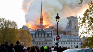 In this April 15, 2019, file photo, smoke and flames rise during a fire at the landmark Notre Dame Cathedral in central Paris.
