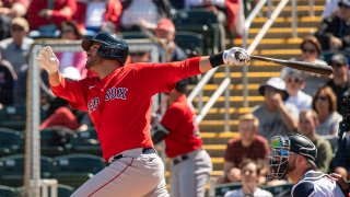 J.D. Martinez of the Boston Red Sox hits a triple during the first inning of a Grapefruit League game against the Minnesota Twins at CenturyLink Sports Complex on Feb. 28, 2020, in Fort Myers, Florida.