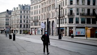 A pedestrian wearing a face mask