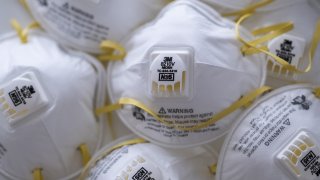 In this April 6, 2020, file photo, 3M Co. 8210V N95 particulate respirators are photographed in Hong Kong, China.