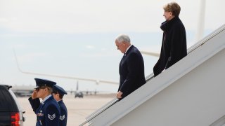 Vice President Mike Pence, center, walks off Air Force Two with Secretary of the Air Force Barbara Barrett at Peterson Air Force Base before Pence gives a graduation address at the Air Force Academy on April 18, 2020 in Colorado Springs, Colorado.