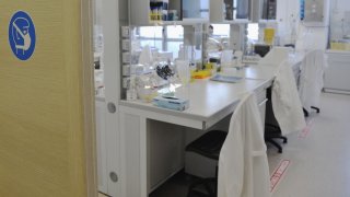 A file photo of lab coats on chairs.