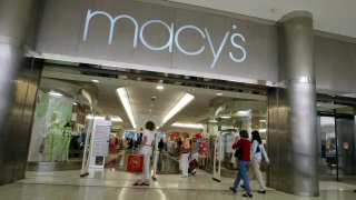 Customers walk out of a Macy's store