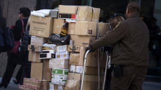 In this Nov. 30, 2015, file photo, a United Parcel Service Inc. (UPS) driver delivers packages on Cyber Monday in New York.