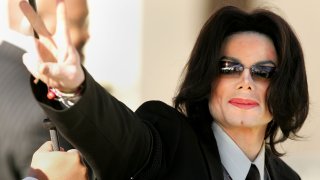 In this March 7, 2005, photo, singer Michael Jackson walks into the Santa Maria Superior Court on the fifth day of his child molestation trial in Santa Maria, California. Jackson is charged in a 10-count indictment with molesting a boy, plying him with liquor and conspiring to commit child abduction, false imprisonment and extortion. He has pleaded innocent.