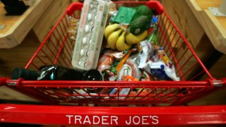 Trader Joe's shopping cart full of groceries.