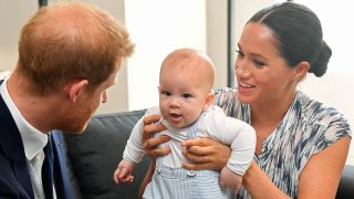 In this Sept. 25, 2019, file photo, Britain's Prince Harry and his wife Meghan, Duchess of Sussex, holding their son Archie, meet Archbishop Desmond Tutu (not pictured) at the Desmond & Leah Tutu Legacy Foundation in Cape Town, South Africa.