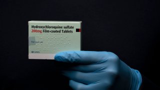 In this photo illustration a pack of Hydroxychloroquine Sulfate medication is held up on March 26, 2020 in London, United Kingdom.