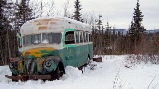 This March 21, 2006 file photo shows the abandoned bus where Christopher McCandless starved to death in 1992 on Stampede Road near Healy, Alaska. An Italian man suffering from frostbite and four other tourists were rescued in the Alaska wilderness after visiting the abandoned bus that's become a lure for adventurers since it was featured in the "Into the Wild" book and movie. Alaska State Troopers say the five were rescued Saturday, Feb. 22, 2020 from a camp they set up after visiting the bus on the Stampede Trail near the interior town of Healy. Sean Penn's movie "Into the Wild" and Jon Krakauer's book of the same name is causing people from all over the world to retrace McCandless's steps to the 1940s-era International Harvester bus near Healy, Alaska where his body was found.