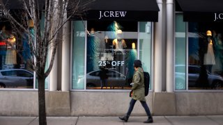 In this March 24, 2014, file photo, a pedestrian passes a J.Crew store in the Shadyside shopping district of Pittsburgh.