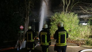 Firemen work at the burned-out monkey house of the zoo in Krefeld, western Germany, on early January 1, 2020. Fire ripped through the monkey house at Krefeld zoo on New Year’s Eve, killing dozens of animals, including orangutans, chimpanzees and marmosets, the management said.