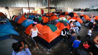 Migrants at a shelter with tents