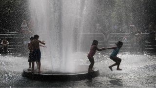 Children playing in water during a heat wave in New York City