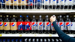 In this Feb. 7, 2012, file photo, a shopper reaches for a bottle of PepsiCo Inc.'s Diet Pepsi soda in a grocery store in Atlanta, Georgia.