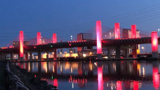 Q bridge lit in red