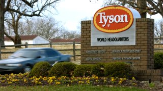 In this Jan. 29, 2006, file photo, a car passes in front of a Tyson Foods Inc., sign at Tyson headquarters in Springdale, Ark.