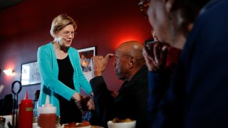 Democratic presidential candidate Sen. Elizabeth Warren, D-Mass., speaks with Bill Mamgum, center, and Shirley Mamgum at EllaEm's Soul Food, Thursday, Feb. 20, 2020, in North Las Vegas, Nev.