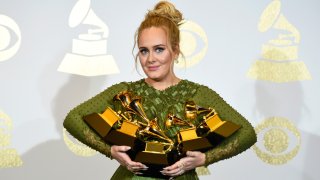 Adele poses with the five awards she won at the 59th Grammy Awards