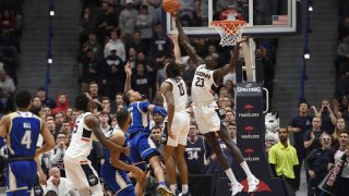 Connecticut’s Akok Akok (23) blocks a shot-attempt by Tulsa’s Darien Jackson (11) in the second half of an NCAA college basketball game, Sunday, Jan. 26, 2020, in Hartford, Conn.