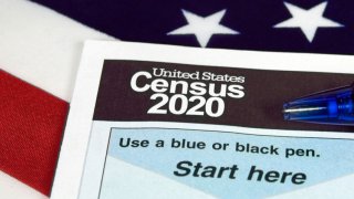 census document form and ball point ink pen on American flag for 2020