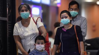 People wear protective facemasks at the Yangon international aiport in Yangon on Jan. 31, 2020.