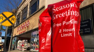 parking meter covered with Season's Greetings sign