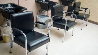 Hair Salon - a row of hair washing sinks and chairs.