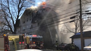 flames shoot from a 3-story home in Hartford
