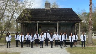 Students from Tulane University's medical school stand in front of former slave quarters at the Whitney Plantation in Wallace, Louisiana, Dec. 14, 2019.