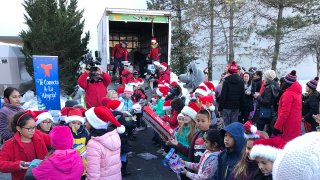 Kids help fill a truck with toys during the NBC Connecticut and Telemundo Connecticut annual toy drive.