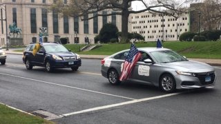 protesters ride by the state capitol to demand the state reopen