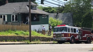 firefighters outside a home in Norwich