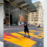person dumps red paint on mural