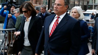 Manuel, right, and Elizabeth Henriquez leave the John Joseph Moakley United States Courthouse in Boston on April 3, 2019. 13 parents were scheduled to appear in federal court in Boston Wednesday for the first time since they were charged last month in a massive college admissions cheating scandal. They were among 50 people - including coaches, powerful financiers, and entrepreneurs - charged in a brazen plot in which wealthy parents allegedly schemed to bribe sports coaches at top colleges to admit their children. Many of the parents allegedly paid to have someone else take the SAT or ACT exams for their children or correct their answers, guaranteeing them high scores. (Photo by Jessica Rinaldi/The Boston Globe via Getty Images)