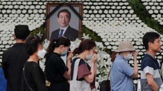 Mourners pass by a memorial altar for late Seoul Mayor Park Won-soon at City Hall Plaza in Seoul, South Korea, Sunday, July 12, 2020. The sudden death of Seoul's mayor, reportedly implicated in a sexual harassment complaint, has prompted an outpouring of public sympathy even as it has raised questions about a man who built his career as a reform-minded politician and self-described feminist.