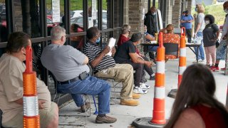 Job seekers exercise social distancing as they wait to be called into the Heartland Workforce Solutions office in Omaha, Neb., Wednesday, July 15, 2020.