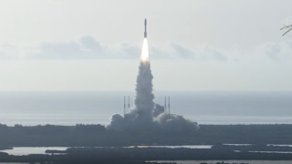 A rocket carrying a Mars rover lifts off.