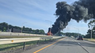 smoke and flames billow from a truck on Interstate 91 in Meriden